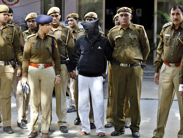 Police escort Uber cab driver Shiv Kumar Yadav (C, in black) who is accused of raping a woman, following his court appearance at the Tis Hazari court on December 8, 2014 in New Delhi, India. Shiv Kumar Yadav was remanded in custody for three days while police investigates the case. Delhi government banned Uber from operating in the Indian capital for failing to do background check on Shiv Kumar, who had previously been accused of assault. 