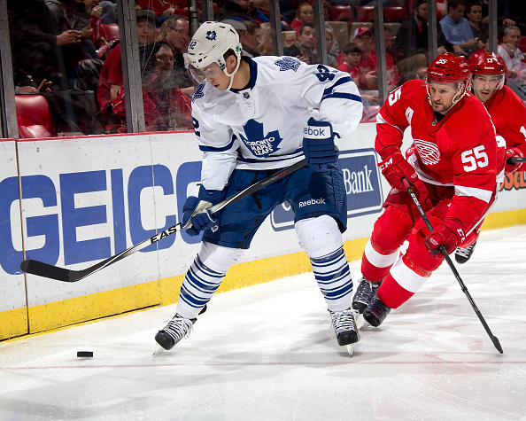 Tyler Bozak #42 of the Toronto Maple Leafs handles the puck as Niklas Kronwall #55 of the Detroit Red Wings trails during an NHL game on December 10, 2014 at Joe Louis Arena in Detroit, Michigan. 