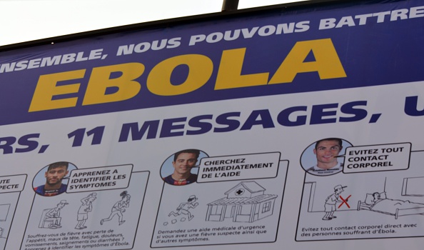 A picture taken on December 17, 2014 shows a board bearing the "11 against Ebola" campaign of World football governing body FIfa, a joint venture with the Confederation of African Football (CAF) and health experts to raise awareness and promote simple preventative measures in the fight against the Ebola virus.
