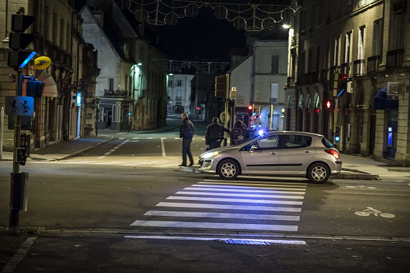 A police vehicle is seen on December 21, 2014 in Dijon, at the site where a driver shouting "Allahu Akbar" ("God is great") ploughed into a crowd injuring 11 people, two seriously, a source close to the investigation said. Two of the people injured in the car attack in the city of Dijon were in a serious condition, a police source said, adding that the driver had been arrested.