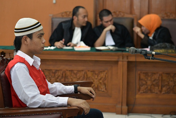 Virgiawan Amin (L), one of five cleaners, listens to the judge's verdict in Jakarta on December 22, 2014 during his hearing over sexual abuse and violence on minors. Five cleaners were jailed on December 22 over the sexual abuse of a young boy at one of Indonesia's most prestigious international schools, in a scandal that has rocked Jakarta's expatriate community.  