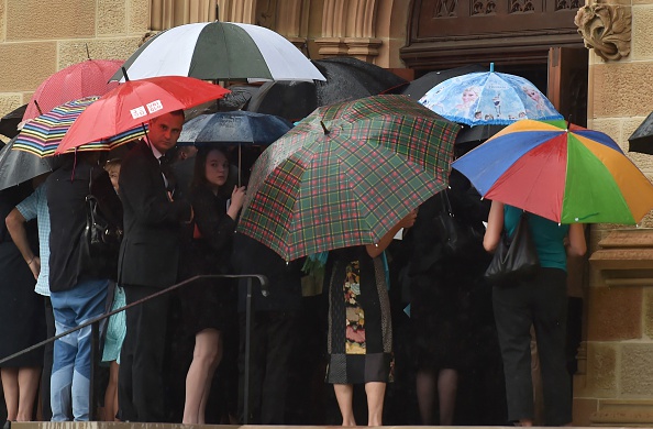Visitors enter the Great Hall at the University of Sydney for the memorial service of Katrina Dawson in Sydney on December 23, 2014. Dawson was killed during a siege at the Lindt cafe in Sydney's Martin Place which saw two hostages Dawson and cafe manager Tori Johnson along with the gunman killed. 