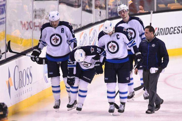 Bryan Little of the Winnipeg Jets leaves the ice with an injury during the third period against the Boston Bruins on November 28th.