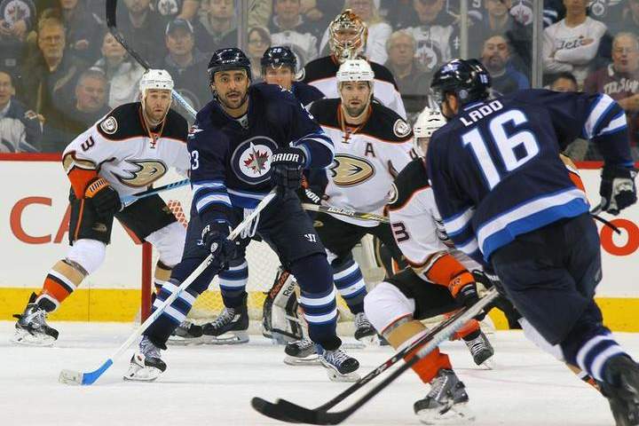 Winnipeg Jet Dustin Byfuglien sets a screen in front of the net as teammate Andrew Ladd plays the puck at the point during first period action against the Anaheim Ducks.