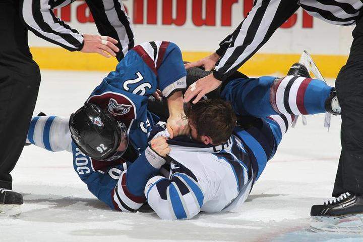 Gabriel Landeskog of the Colorado Avalanche and Andrew Ladd of the Winnipeg Jets are separated by officials after fighting at the Pepsi Center on Thursday in Denver, Colo.