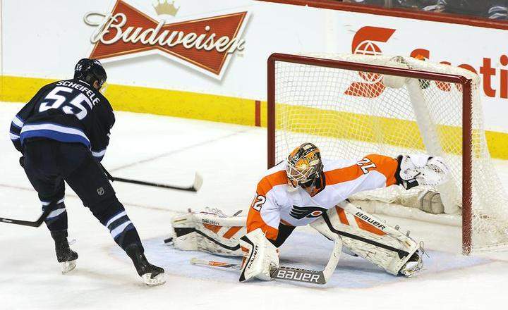Rookie goaltender Rob Zepp of the Philadelphia Flyers slides across the crease as he makes a toe save on Mark Scheifele of the Winnipeg Jets on Sunday at the MTS Centre in Winnipeg.