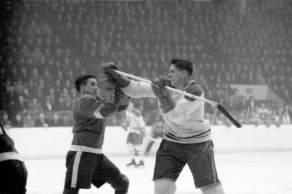 Montreal Canadiens Jean Béliveau #4 in action vs Detroit Red Wings Ted Lindsay #7 during fight, Montreal, CAN 2/17/1955.