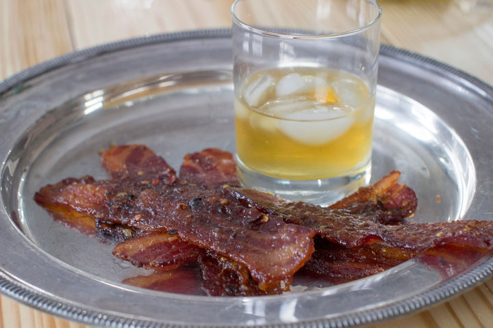 This Dec. 1, 2014 photo shows slow candied bacon and winter orchard Scotch in Concord, N.H. Not everything for New Year’s Eve needs to be fussy, bubbly or frilly. To go with Scotch whisky try slowly candied bacon.