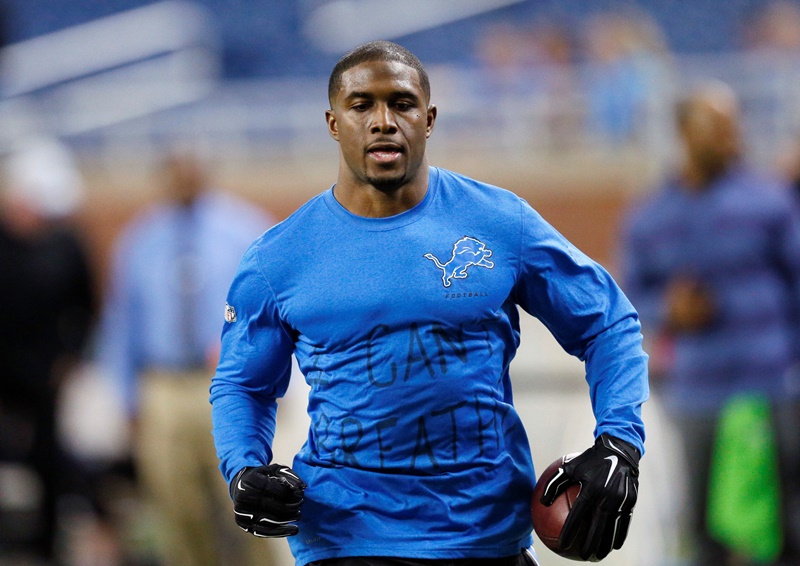 Wearing a Detroit Lions shirt with "I can't breathe" written on the front, running back Reggie Bush runs through pre-game warmups in an NFL football game against the Tampa Bay Buccaneers in Detroit, Sunday, Dec. 7, 2014. 