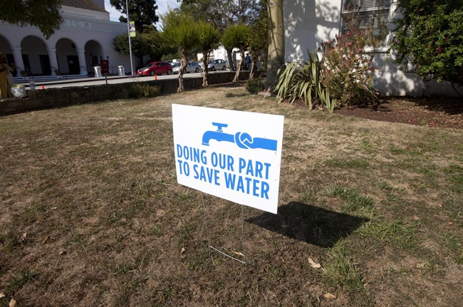 In this July 29, 2014 file photo, a water conservation sign is displayed outside of City Hall in Santa Cruz, Calif. 