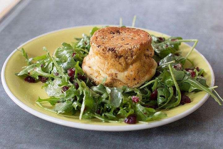 This Dec. 1, 2014 photo shows cheddar and walnut souffles on arugula with pear dressing in Concord, N.H. A souffle is comprised of two elements, a base and a leavener. It’s worth noting that the base must be highly seasoned.