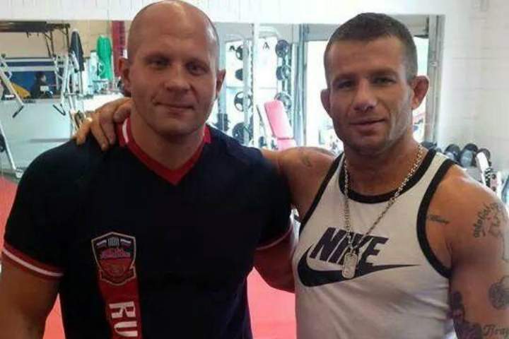 Ryan Chiappe (right), seen here posing with MMA legend Fedor Emelianenko, faces several criminal charges.  