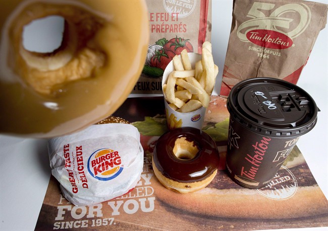 Burger King and Tim Hortons products are pictured in North Vancouver, Thursday, Sept. 25, 2014. Tim Hortons Inc. shareholders voted in favour of the takeover by Burger King Worldwide Inc. on Tuesday. The vote follows the approval by Ottawa last week of the deal following a review under the Investment Canada Act. THE CANADIAN PRESS/Jonathan Hayward