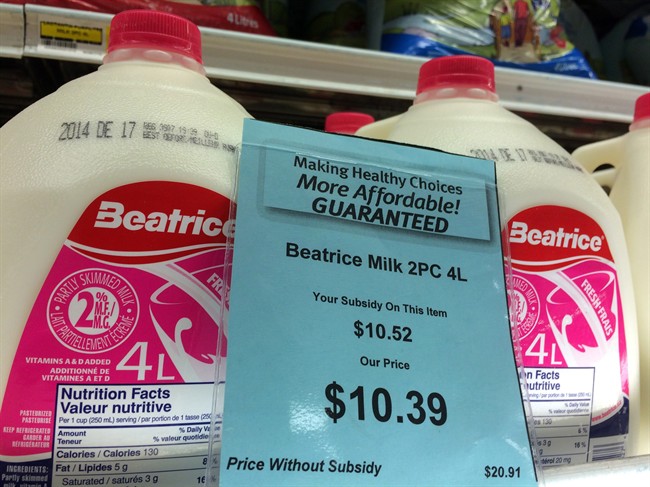 A price tag lists the price and subsidy of a 4 L jug of milk at a grocery store in Iqaluit, Nunavut on Monday, December 8, 2014. 