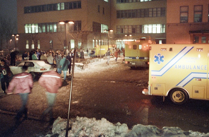 Paramedics and crowds are pictured outside the Ecole Polytechnique after gunman Marc Lepine opened fire at the school in Montreal on Dec. 6, 1989.