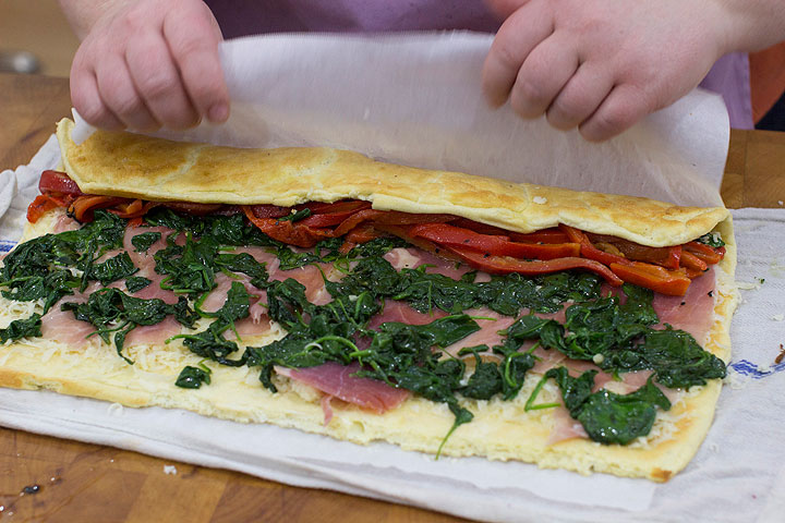 This Dec. 1, 2014 photo shows the making of and egg roulade stuffed with prosciutto, spinach and roasted red pepper in Concord, N.H. Think of a roulade as a big edible cigar-shaped container for just about any filling of your choice.