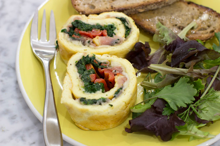 This Dec. 1, 2014 photo shows egg roulade stuffed with prosciutto, spinach and roasted red pepper in Concord, N.H. Think of a roulade as a big edible cigar-shaped container for just about any filling of your choice.