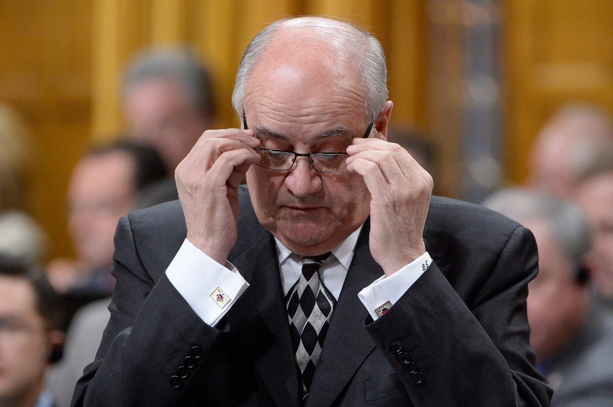 Veterans Affairs Minister Julian Fantino adjusts his glasses during question period in the House of Commons, Monday, December 8, 2014 in Ottawa. THE CANADIAN PRESS/Adrian Wyld.