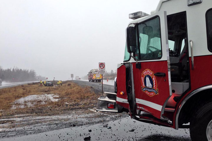 A fire truck was struck by a vehicle on Highway 103 outside Halifax on Wednesday morning, injuring two firefighters.