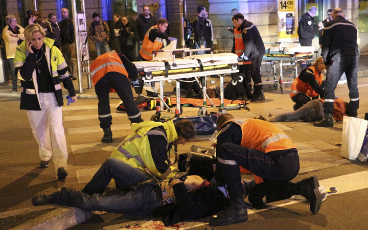 This photo provided Monday, Dec. 22, 2014 by local newspaper Le Bien Public shows rescue workers tending at victims after a driver deliberately slammed into passersby in several spots in Dijon, central France, Sunday Dec. 21, 2014. 