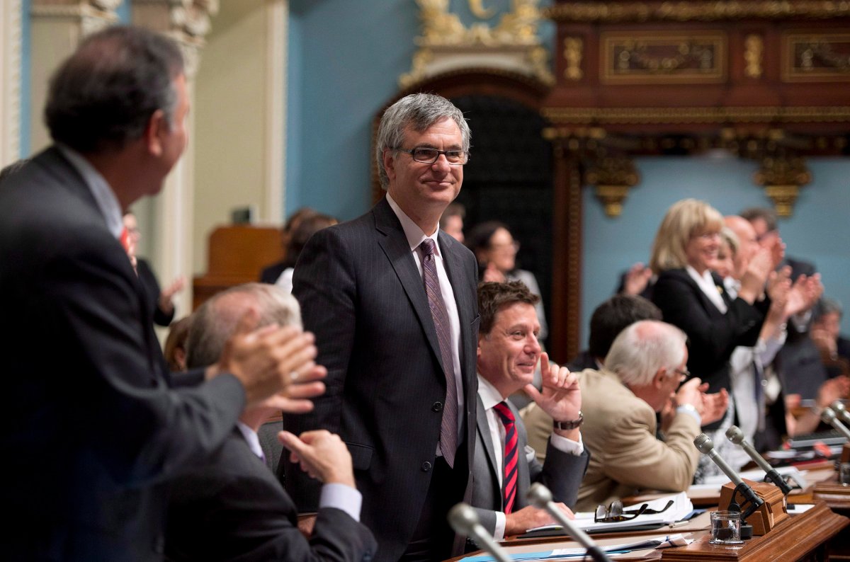 Quebec Opposition Leader Jean-Marc Fournier, centre, stands with a smile as he is offered to answer a second opposition question on shale gas.