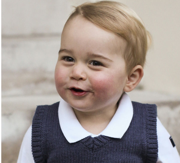  In this photo provided by The Duke and Duchess of Cambridge and taken in late Nov. 2014, Britain's Prince George poses for a photograph in a courtyard at Kensington Palace, London. 