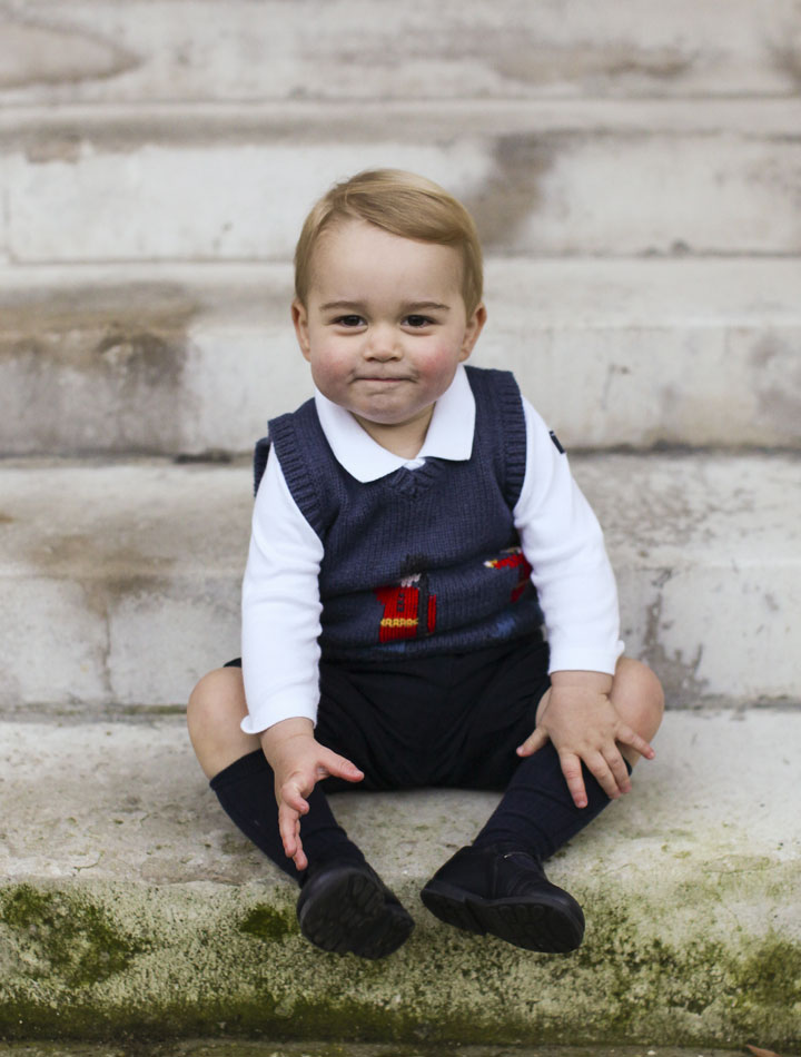In this photo provided by The Duke and Duchess of Cambridge and taken in late Nov. 2014, Britain’s Prince George poses for a photograph in a courtyard at Kensington Palace, London.