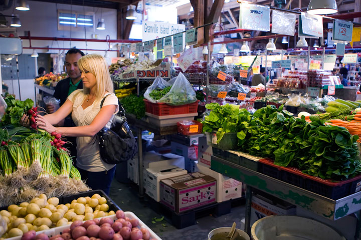 This undated image provided by Tourism Vancouver shows people examining produce at a stall at the Granville Island Public Market in Vancouver.