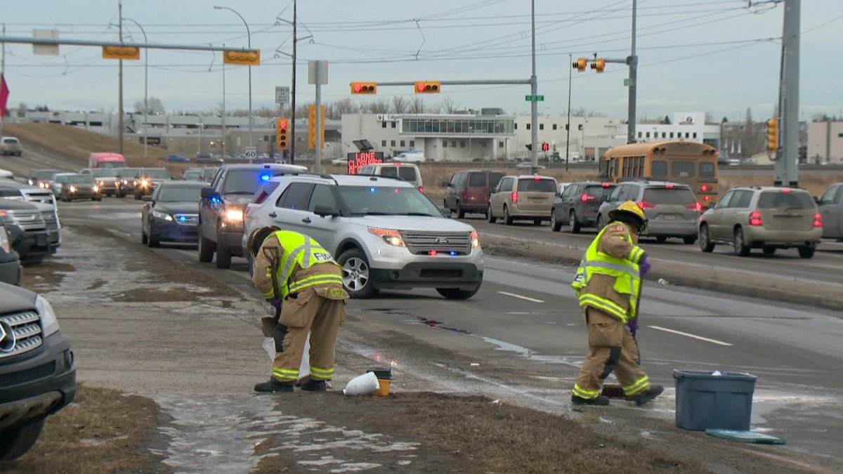 Firefighters clean up the scene of a southeast crash where a cube van ran over a pedestrian by Heritage Drive on Thursday.