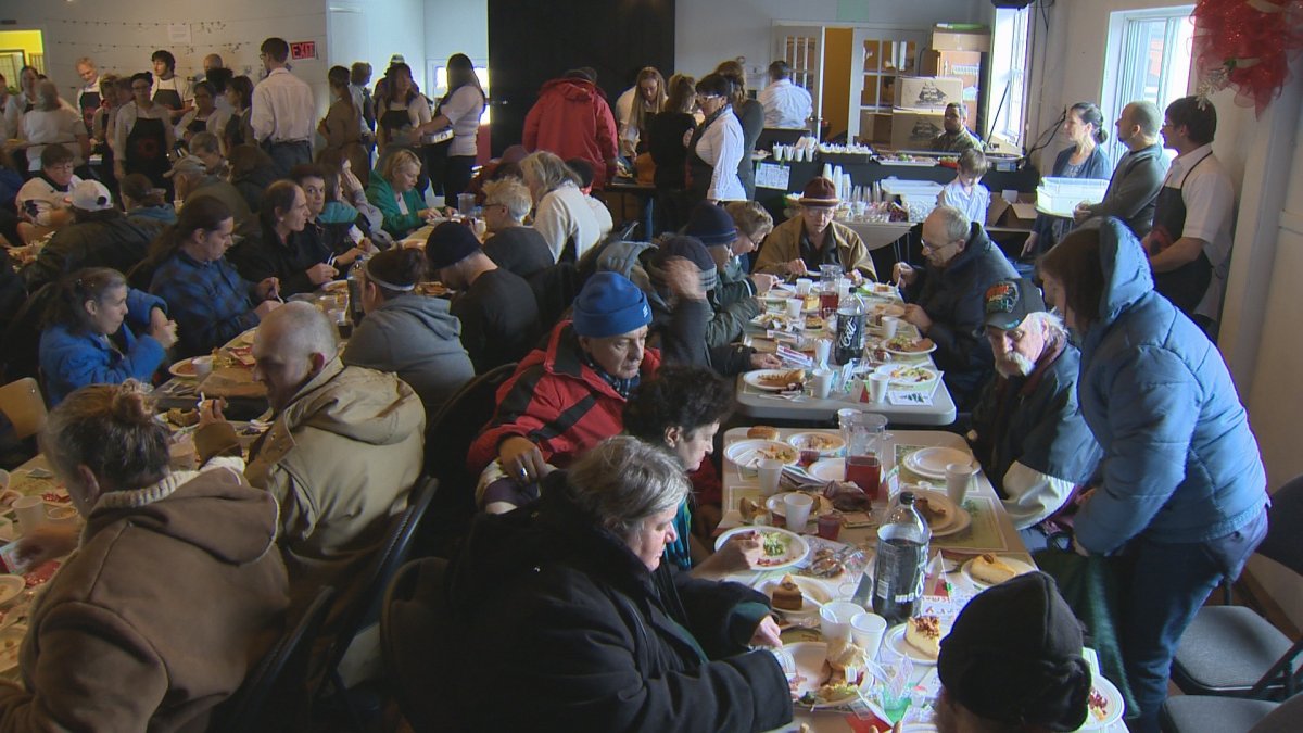 Diners enjoy the annual holiday dinner served at Soul's Harbour Rescue Mission on New Year's Eve.