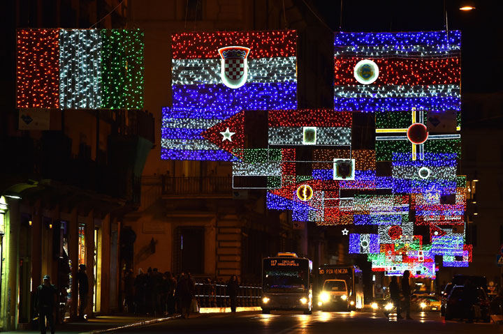 A picture shows christmas lights representing the national flags of different countries in the Via del Corso in Rome on December 9, 2014.