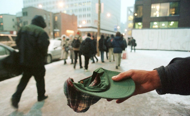 A homeless man begs in downtown Montreal.