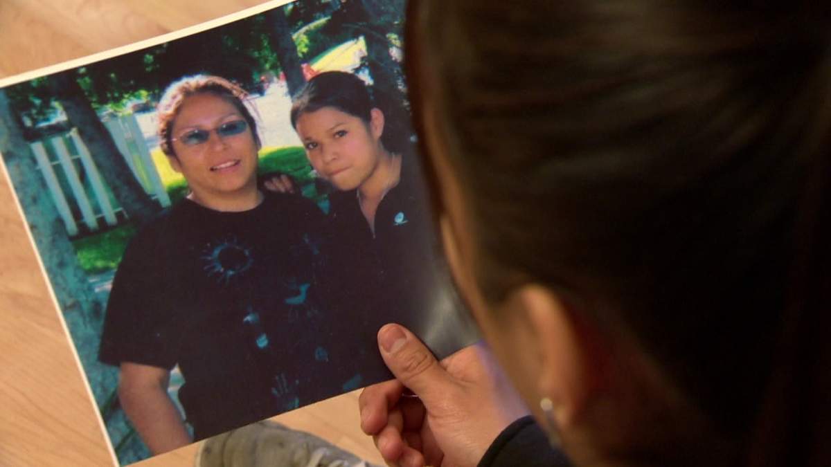 Tia Ledesma looks at a photograph of her mother Cherry Ledesma.
