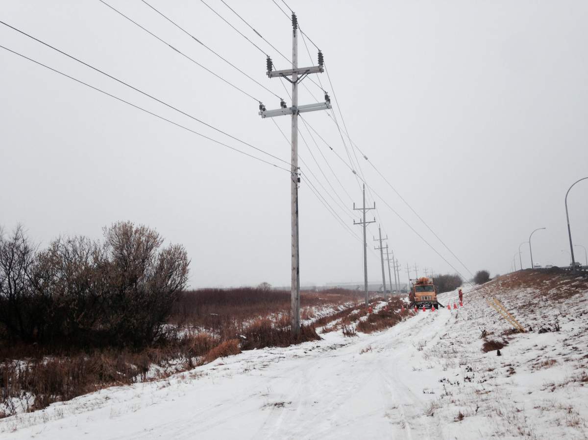 Hydro crews repair downed power lines Saturday afternoon.