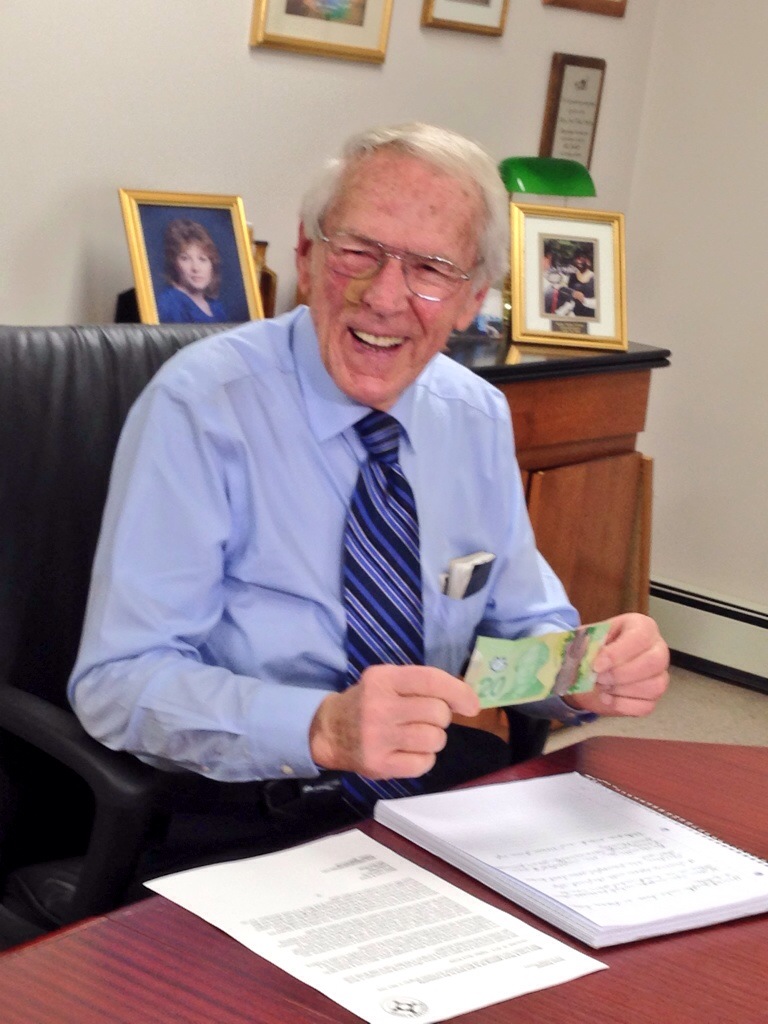 Mel Boutilier receives his first $20 donation to his Metro Share & Care organization