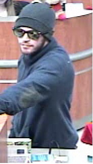 The suspect got away with some cash and was armed with a gun.