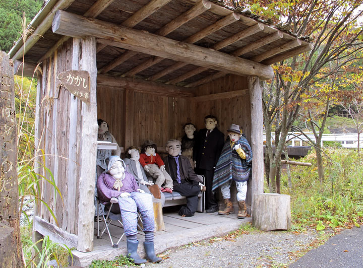 In this Thursday, Nov. 6, 2014 photo, scarecrows wait for a bus at a bus stop for scarecrows in Nagoro, Tokushima Prefecture, southern Japan.