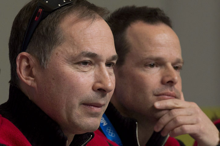 Canadian Olympic Team Chef de Mission Steve Podborski (left) and Assistant Chef de Mission Jean-Luc Brassard listen to a question during a news conference at the Sochi Winter Olympics Thursday February 6, 2014 in Sochi, Russia. 