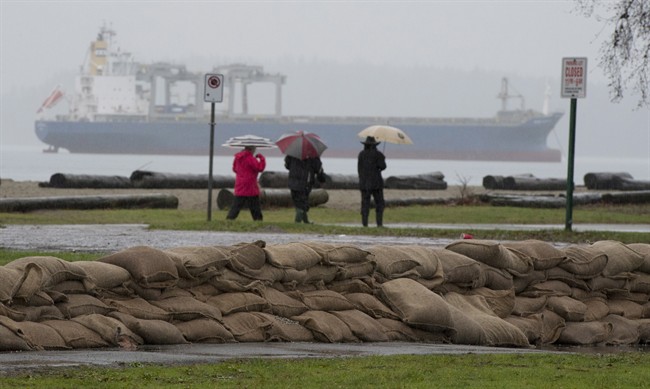 Sandbags are placed along the shores of Locarno Beach in Vancouver, Wednesday Dec. 10, 2014. 