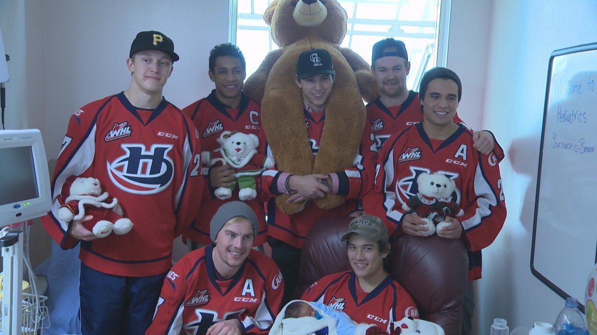 The Lethbridge Hurricanes pose while handing out teddy bears at Chinook Regional Hospital.