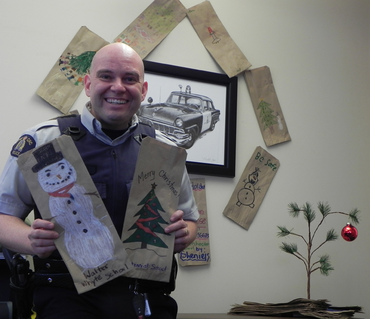 Const. Paul Human holds some of the liquor bags decorated by children in Selkirk, Manitoba.