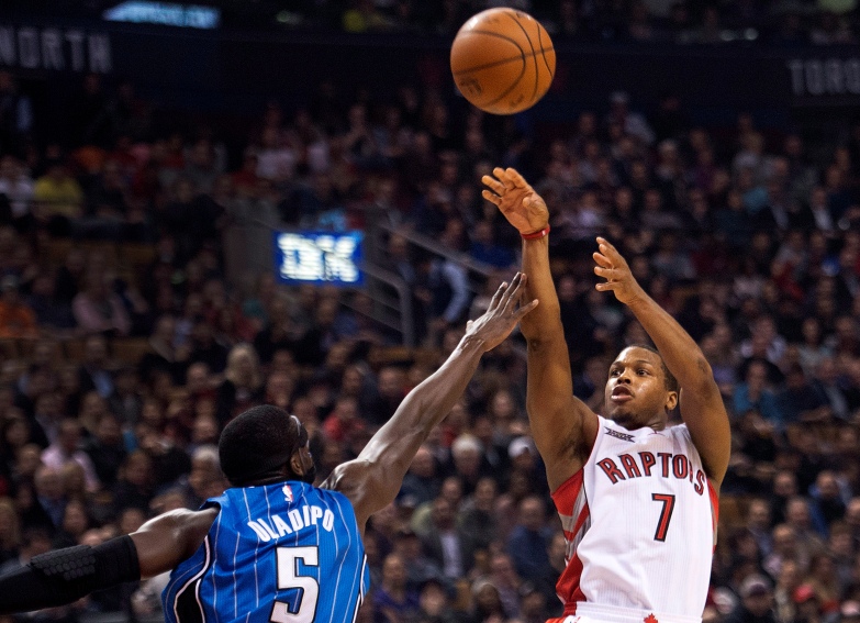 Toronto Raptors guard Kyle Lowry (7) makes a jump shot past Orlando Magic guard Victor Oladipo (5) during first half NBA basketball action in Toronto on Monday, December 15, 2014. 