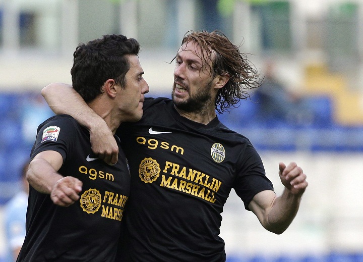 Hellas Verona midfielder Marquinho, of Brazil, left, celebrates with his teammate midfielder Marco Donadel after he scored during an Italian Serie A soccer match between Lazio and Verona at Rome's Olympic stadium, Monday, May 5, 2014. 