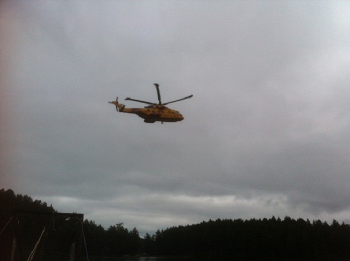 A helicopter flies over Mayne Island on December 13, 2014.