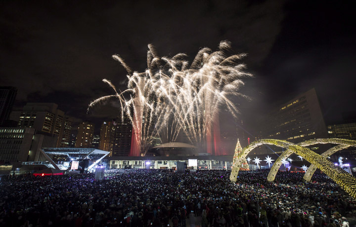Fireworks explode during New Year's Eve celebrations at Nathan Phillips Square in Toronto, Wednesday, January 1, 2014.