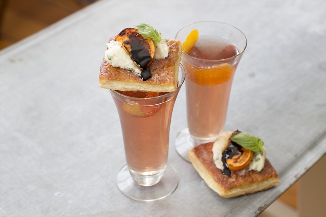 This Dec. 1, 2014 photo shows spiced prosecco and honey broiled persimmon tarts in Concord, N.H. For our bubbles go for Sorel liqueur, which gives the cocktail a gently spiced, lightly fruit flavor.