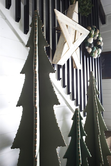 In this 2014 photo from Atlanta Homes & Lifestyles, designer Brian Patrick Flynn created flat-packing upholstered Christmas tree sculptures from plywood, batting and green fabrics, for an alternative approach to holiday trees. During the off-season months, the trees collapse into two pieces which store easily in closets.