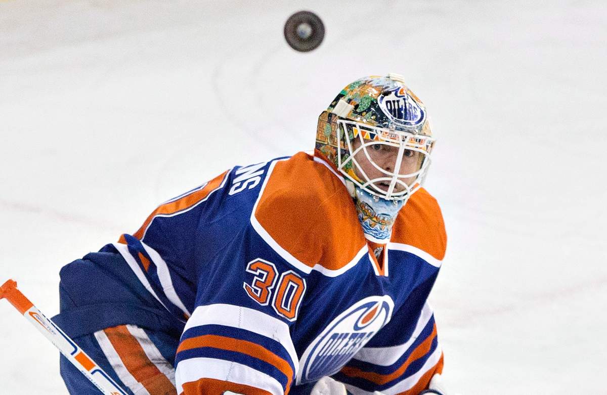 Edmonton Oilers goalie Ben Scrivens (30) watches the rebound against the Los Angeles Kings during third period NHL hockey action in Edmonton, Alta., on Tuesday December 30, 2014.