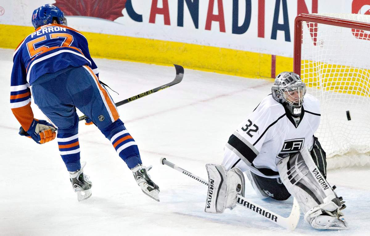 Los Angeles Kings goalie Jonathan Quick (32) is scored on by Edmonton Oilers’ David Perron (57) during shootout NHL hockey action in Edmonton, Alta., on Tuesday December 30, 2014.