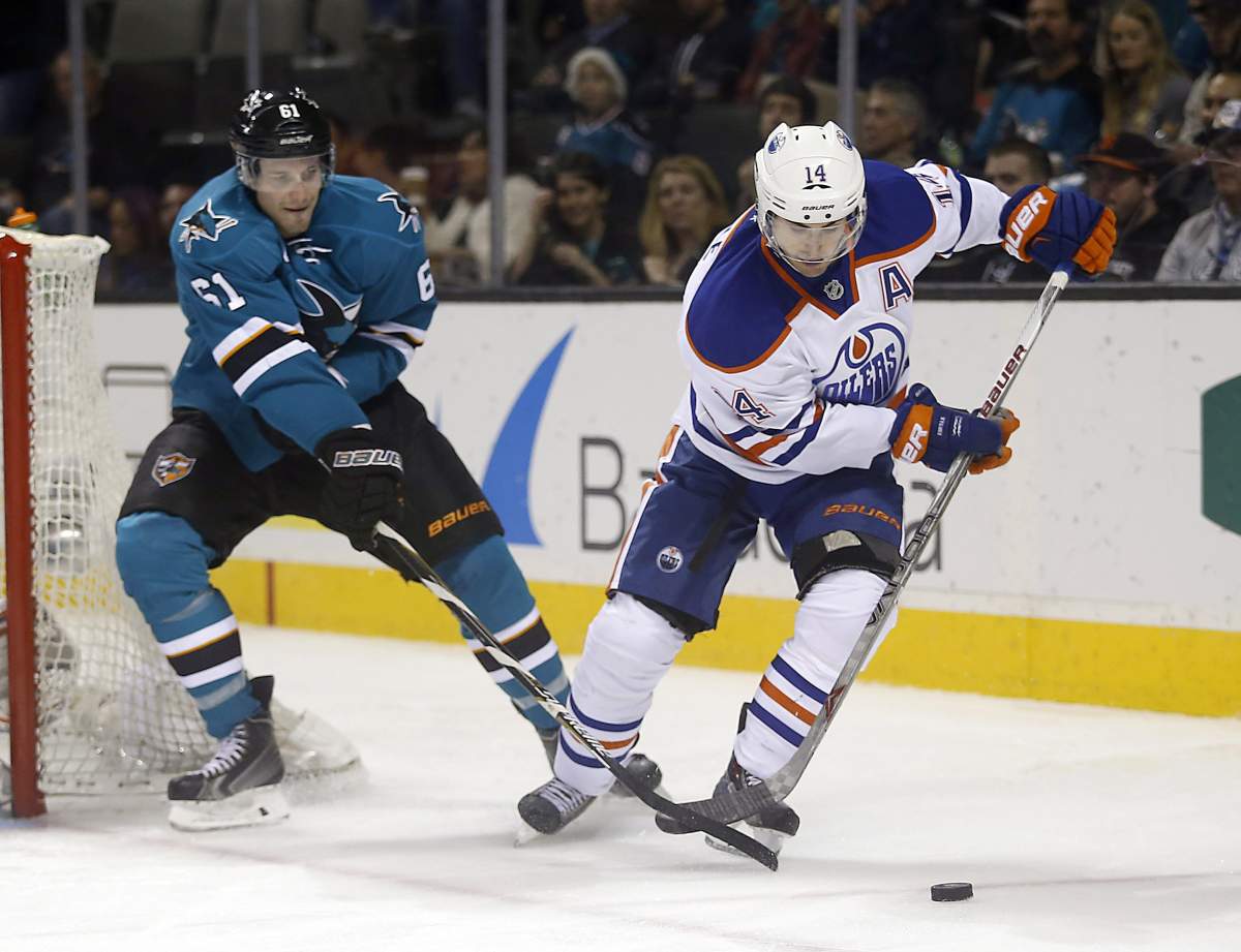 Edmonton Oilers right wing Jordan Eberle (14) skates past San Jose Sharks defenseman Justin Braun (61) during the second period of an NHL hockey game Tuesday, Dec. 9, 2014, in San Jose, Calif.